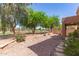 Private backyard featuring a serene desert landscape with gravel, pavers, plants and a view of the community golf course at 7029 S Golfside Ln, Phoenix, AZ 85042