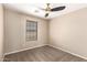 This bedroom features neutral walls, plush carpeting, and a ceiling fan at 7029 S Golfside Ln, Phoenix, AZ 85042