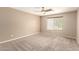 Spacious bedroom featuring carpeted floors, a window and ceiling fan at 7029 S Golfside Ln, Phoenix, AZ 85042