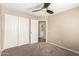 Spacious bedroom boasts plush carpeting, a closet, and a door to bathroom at 7029 S Golfside Ln, Phoenix, AZ 85042