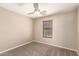 Cozy bedroom featuring neutral walls, plush carpeting, and a ceiling fan for added comfort at 7029 S Golfside Ln, Phoenix, AZ 85042