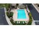 Aerial view of a refreshing community pool with lounge chairs, manicured landscaping, and convenient access to nearby streets at 7029 S Golfside Ln, Phoenix, AZ 85042