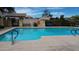 Well-maintained community pool with clear water, safety signage, and comfortable seating for residents to relax and enjoy at 7029 S Golfside Ln, Phoenix, AZ 85042