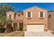 Inviting two-story home featuring a two-car garage and a cozy front porch, enhanced by desert landscaping at 7029 S Golfside Ln, Phoenix, AZ 85042