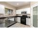Bright kitchen featuring white cabinets, stainless steel appliances, and dark countertops at 7029 S Golfside Ln, Phoenix, AZ 85042