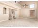 Spacious open concept living area featuring high ceilings, clerestory windows, and neutral tile flooring at 7029 S Golfside Ln, Phoenix, AZ 85042