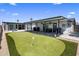 Beautiful backyard featuring a putting green, covered patio with ceiling fans, and outdoor seating area at 7707 E Earll Dr, Scottsdale, AZ 85251