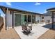 Backyard patio with outdoor seating and sliding glass doors to interior at 7707 E Earll Dr, Scottsdale, AZ 85251
