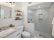 Bright bathroom features a glass-enclosed shower, floating shelves, and modern fixtures at 7707 E Earll Dr, Scottsdale, AZ 85251