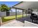 A spacious covered patio offers ceiling fans and a view of the putting green and backyard at 7707 E Earll Dr, Scottsdale, AZ 85251
