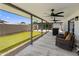 This home features a covered patio with ceiling fans, outdoor furniture, and a view of the putting green at 7707 E Earll Dr, Scottsdale, AZ 85251