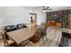 Open concept room with decorative wall, vinyl floor, and dining table with view into living room at 7707 E Earll Dr, Scottsdale, AZ 85251