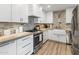 Modern kitchen featuring white cabinets, stainless steel appliances, designer tile backsplash and ample counter space at 7707 E Earll Dr, Scottsdale, AZ 85251