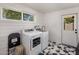 Well-lit laundry room features a washer, dryer, and a window providing natural light at 7707 E Earll Dr, Scottsdale, AZ 85251
