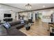 Spacious living room with mirrored wall, plush seating, and hardwood floors, blending style and comfort at 7707 E Earll Dr, Scottsdale, AZ 85251
