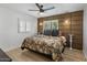 Serene main bedroom featuring stylish accent wall, ample natural light, and modern ceiling fan at 7707 E Earll Dr, Scottsdale, AZ 85251