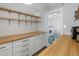 A view of a bright, well-organized pantry with ample storage and a laundry room at 7707 E Earll Dr, Scottsdale, AZ 85251