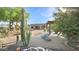 Expansive backyard featuring desert landscaping, a covered patio, and a fire pit area for outdoor relaxation at 833 N 110Th St, Mesa, AZ 85207