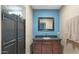 Bathroom with blue accent wall, wood vanity and dark fixtures at 833 N 110Th St, Mesa, AZ 85207