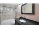 Bathroom with single sink vanity, tub and shower combo with dark fixtures at 833 N 110Th St, Mesa, AZ 85207