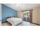 Bright bedroom with white queen-sized bed and sliding door to patio at 833 N 110Th St, Mesa, AZ 85207