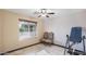 Bedroom with tile floors, ceiling fan, and large window for natural light at 833 N 110Th St, Mesa, AZ 85207