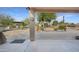 Covered patio offers a serene view of the expansive, landscaped backyard with multiple seating and dining areas at 833 N 110Th St, Mesa, AZ 85207