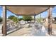 Covered patio with an outdoor kitchen and seating area overlooking a spacious backyard at 833 N 110Th St, Mesa, AZ 85207