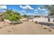 Long desert driveway with a decorative wrought iron gate entry to property at 833 N 110Th St, Mesa, AZ 85207