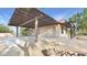 Exterior of a home featuring an attached garage with a covered parking area and desert landscaping at 833 N 110Th St, Mesa, AZ 85207