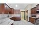 A well lit kitchen with marble countertops and dark wood cabinets at 833 N 110Th St, Mesa, AZ 85207