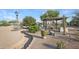 Landscaped backyard features a covered patio, outdoor kitchen, and lush greenery, perfect for outdoor living at 833 N 110Th St, Mesa, AZ 85207