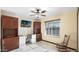 Home office with built-in wooden desk, cabinets, ceiling fan and light at 833 N 110Th St, Mesa, AZ 85207