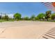 Exterior view of the community basketball court surrounded by trees and green spaces at 915 W Orchard Ln, Litchfield Park, AZ 85340