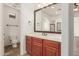 Bathroom featuring wooden cabinets, a white countertop, and a toilet area for added privacy at 915 W Orchard Ln, Litchfield Park, AZ 85340