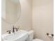 Clean bathroom featuring sleek fixtures, a wall mirror, and a toilet at 915 W Orchard Ln, Litchfield Park, AZ 85340