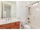 Well-lit bathroom features a vanity with wood cabinets and a convenient shower-tub combo at 915 W Orchard Ln, Litchfield Park, AZ 85340