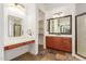 Well-lit bathroom with dual vanities and a makeup area, leading into the spacious walk-in closet at 915 W Orchard Ln, Litchfield Park, AZ 85340