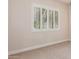 Clean bedroom with neutral carpet, baseboards, light walls, and large shuttered window at 915 W Orchard Ln, Litchfield Park, AZ 85340