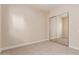 Clean, carpeted bedroom with mirrored closet doors, neutral walls and baseboards at 915 W Orchard Ln, Litchfield Park, AZ 85340