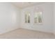 Bright bedroom with dual shuttered windows and neutral carpeting, creating a serene retreat at 915 W Orchard Ln, Litchfield Park, AZ 85340