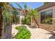 Outdoor courtyard with lush tropical landscaping and a brick-paved ground at 915 W Orchard Ln, Litchfield Park, AZ 85340