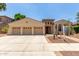 Charming single-Gathering home features a three-car garage, desert landscaping, and a tile roof at 915 W Orchard Ln, Litchfield Park, AZ 85340