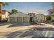 Charming desert home with a large three car garage, beautiful desert landscaping and sunset at 915 W Orchard Ln, Litchfield Park, AZ 85340