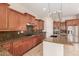 Gourmet kitchen boasting ample counter space, wood cabinets, and updated appliances at 915 W Orchard Ln, Litchfield Park, AZ 85340