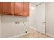 Laundry room with utility sink, cabinet, and tile flooring, plus easy access to hookups at 915 W Orchard Ln, Litchfield Park, AZ 85340