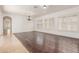 Open-concept living room with hardwood floors, shuttered windows, and modern lighting fixtures at 915 W Orchard Ln, Litchfield Park, AZ 85340