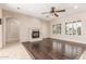 Elegant living space boasting a stone fireplace, hardwood floors, and natural light from shuttered windows at 915 W Orchard Ln, Litchfield Park, AZ 85340