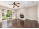 Cozy living room with hardwood floors, fireplace, and sliding glass doors to the backyard at 915 W Orchard Ln, Litchfield Park, AZ 85340