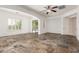 Bright living room with tiled flooring, plantation shutters, and seamless access to the outdoor pool at 915 W Orchard Ln, Litchfield Park, AZ 85340